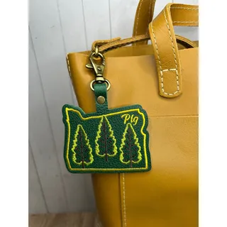 Photo of Portland Leather Bag Charm Oregon Purse Charm PNW Oregon Pebbled Gold Stitched