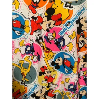 Photo of NWT Disney Parks World AOP Faux Stickers Vintage 50th Anniversary Tee M